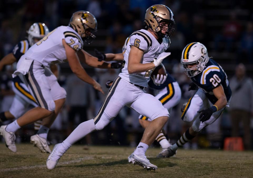 Jasper’s Carter Holsworth (6) breaks for the end zone against Castle’s Zach Schirmer (20) during their game at John Lidy Field Friday night, Sept. 30, 2022.