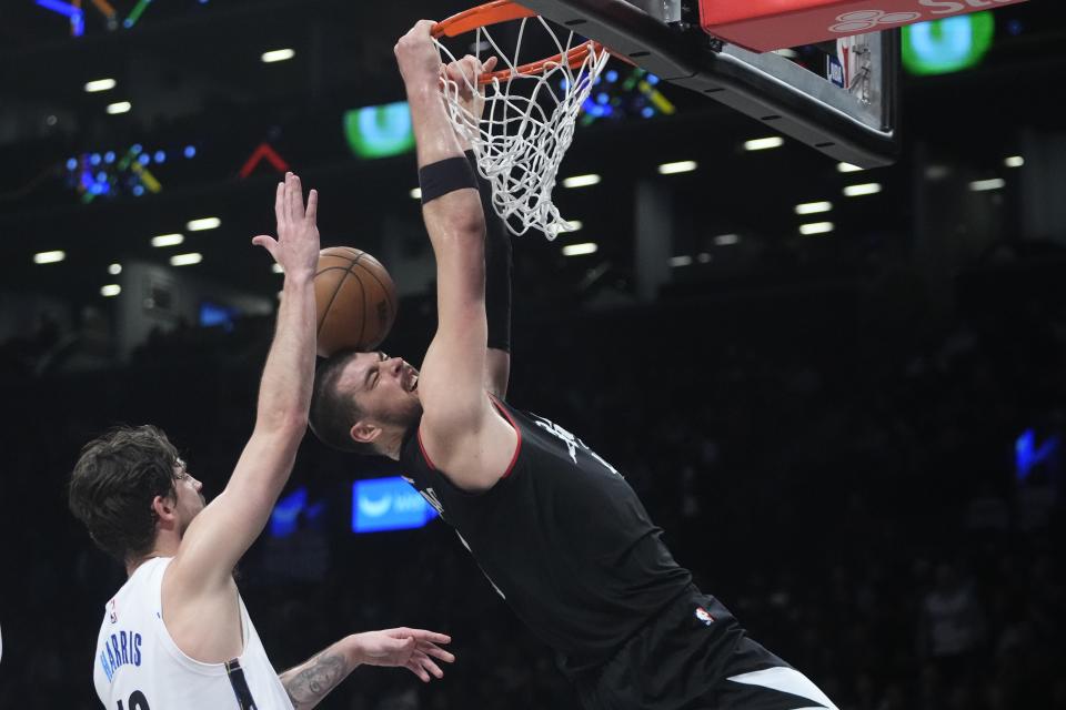 Los Angeles Clippers' Ivica Zubac, right, dunks the ball in front of Brooklyn Nets' Joe Harris during the second half of an NBA basketball game, Monday, Feb. 6, 2023, in New York. The Clippers won 124-116.(AP Photo/Frank Franklin II)