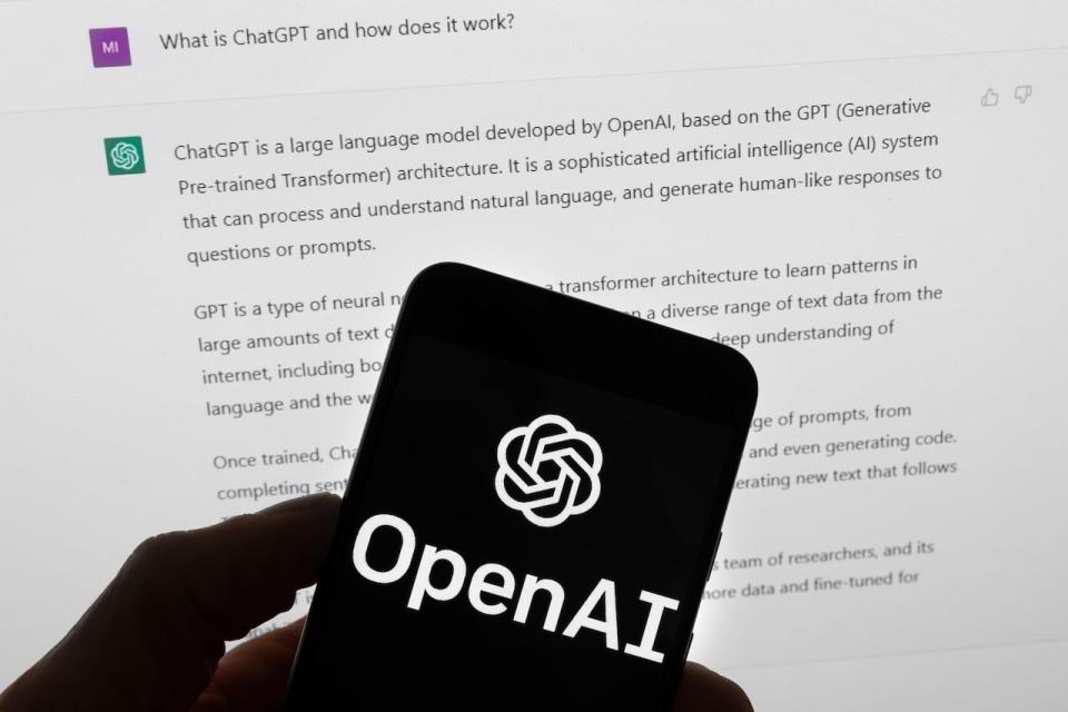 FILE - The OpenAI logo is seen on a mobile phone in front of a computer screen which displays output from ChatGPT, Tuesday, March 21, 2023, in Boston.  White House officials concerned about AI chatbots' potential for societal harm and the Silicon Valley powerhouses rushing them to market are heavily invested in a three-day competition ending Sunday, Aug. 13, at the DefCon hacker convention in Las Vegas. Some 3,500 competitors have tapped on laptops seeking to expose vulnerabilities in eight leading large-language models representative of technology’s next big thing. 