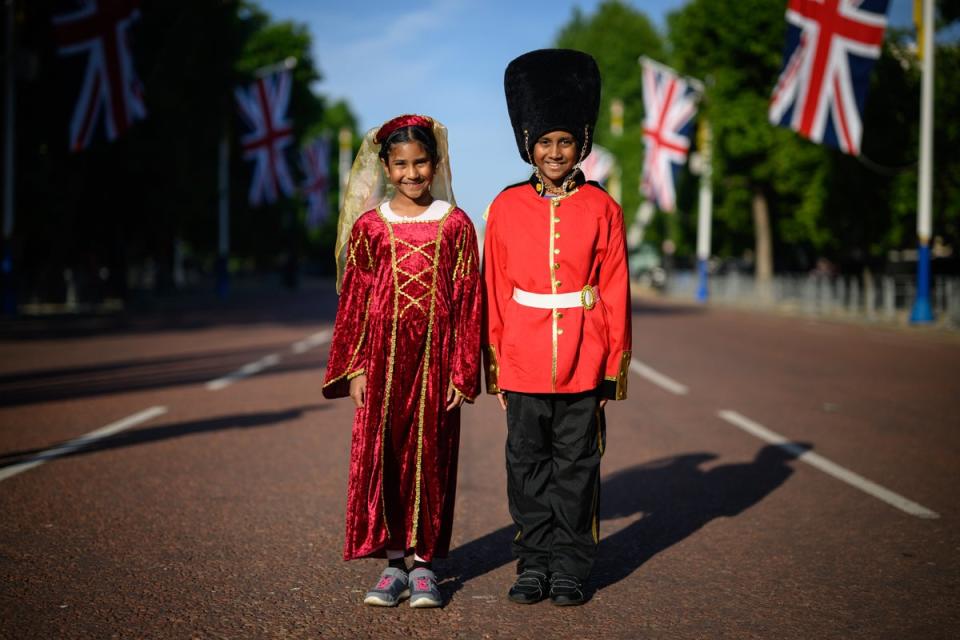 Royal fans Caellia (L) and Yoshilen wear costumes as they arrive on the Mall to celebrate the first day of celebrations to mark the Platinum Jubilee of Queen Elizabeth II, on June 02 (Getty Images)