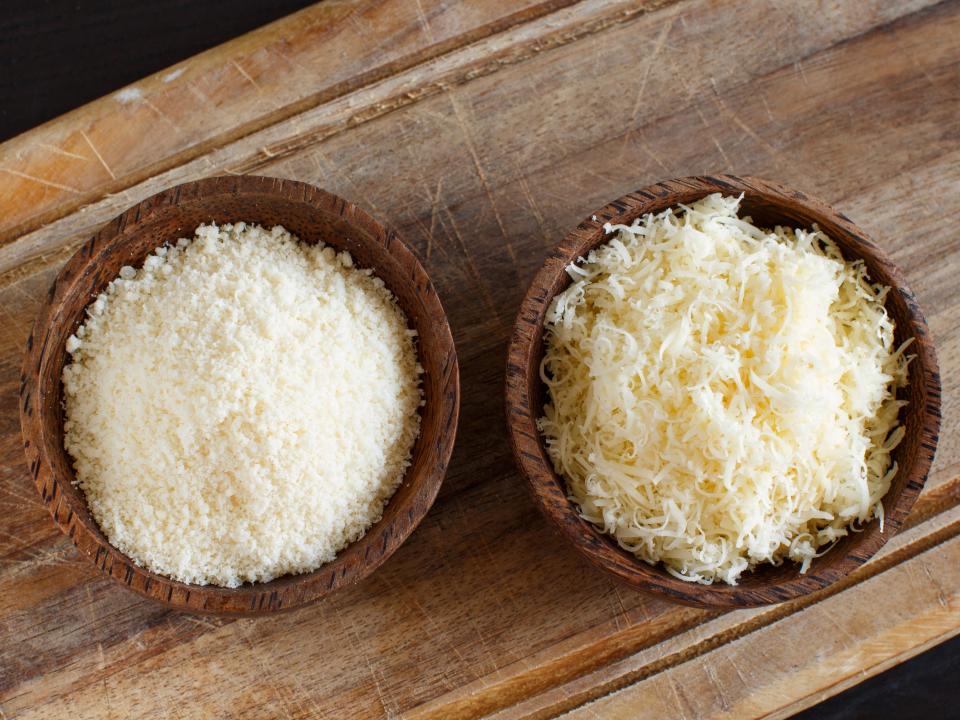 2 Bowls with grated parmesan cheese top view