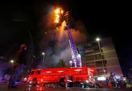 The corporate building of the multinational energy company ENEL, is seen on fire during a protest against the increase in the subway ticket prices in Santiago