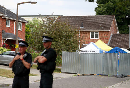 Police officers stand on duty outside Sergei Skripal's home in Salisbury, Britain, July 19, 2018. REUTERS/Hannah McKay