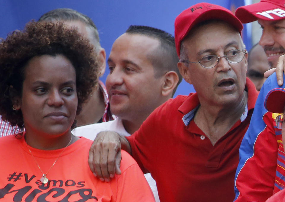 FILE - In this April 6, 2019 file photo, Luis Alfredo Motta Dominguez, right, attends a pro-government rally in Caracas, Venezuela. On Thursday, March 26, 2020, the U.S. Justice Department made public it has charged in several indictments against Venezuelan President Maduro and his inner circle, including Motta, that the leader has effectively converted Venezuela into a criminal enterprise at the service of drug traffickers and terrorist groups as he and his allies stole billions from the South American country. (AP Photo/Ariana Cubillos, File)