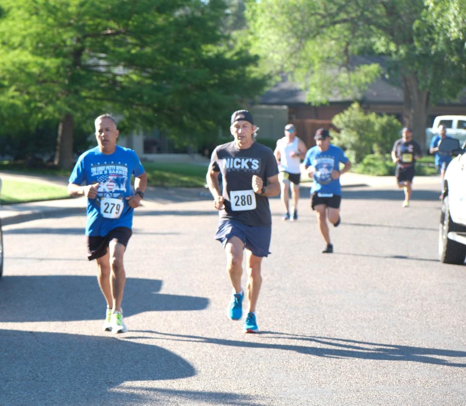 A group of runners finish the first leg of the Chief Petty Officer Jack R. Barnes Run For the Fallen Saturday morning at Stephen F Austin Park in Amarillo.