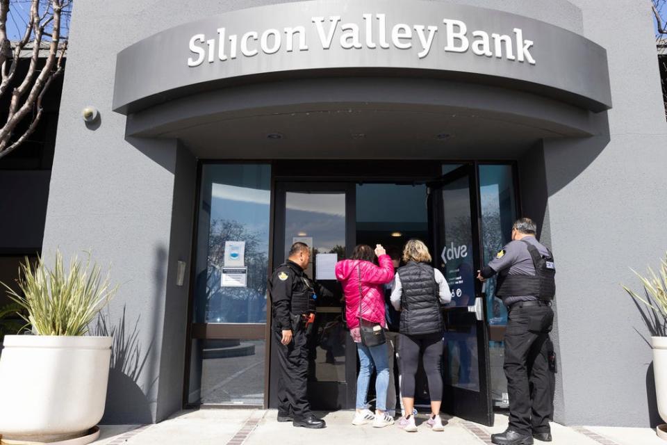 Security guards let individuals enter the Silicon Valley Bank's headquarters in Santa Clara, Calif., on March 13.