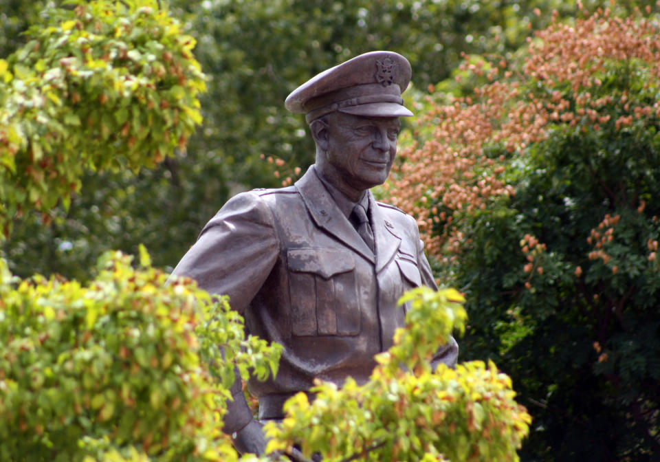 This Aug. 4, 2012 photo shows a large bronze statue of Gen. Eisenhower that stands over the grounds of his library, museum and boyhood home in Abilene, Kansas. The museum plans to launch a new World War II exhibit begging in the summer of 2013. A new World War II exhibit starting this summer at the Eisenhower Presidential Library and Museum will pay tribute to the millions who fought, but organizers also have another purpose for the ambitious three-year project: getting young people engaged in the war's relevance.(AP Photo/John Milburn)