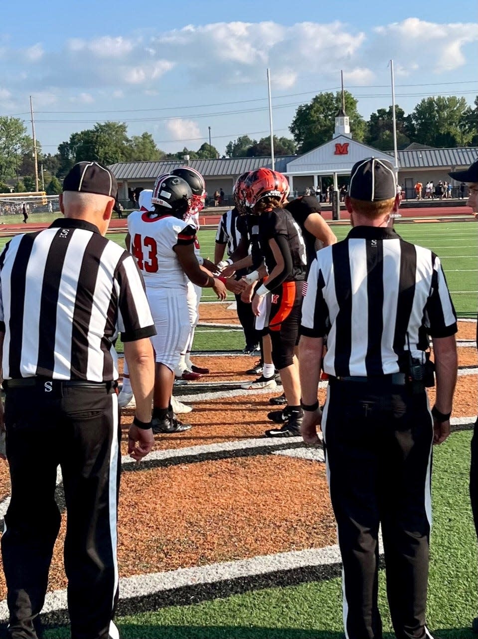 Marion Harding's football captains meet at midfield with their counterparts from Mount Vernon before the start of last week's game at Mount Vernon.  The Presidents will be on the road again this week, traveling to Ashland for the Erie Bell trophy game.