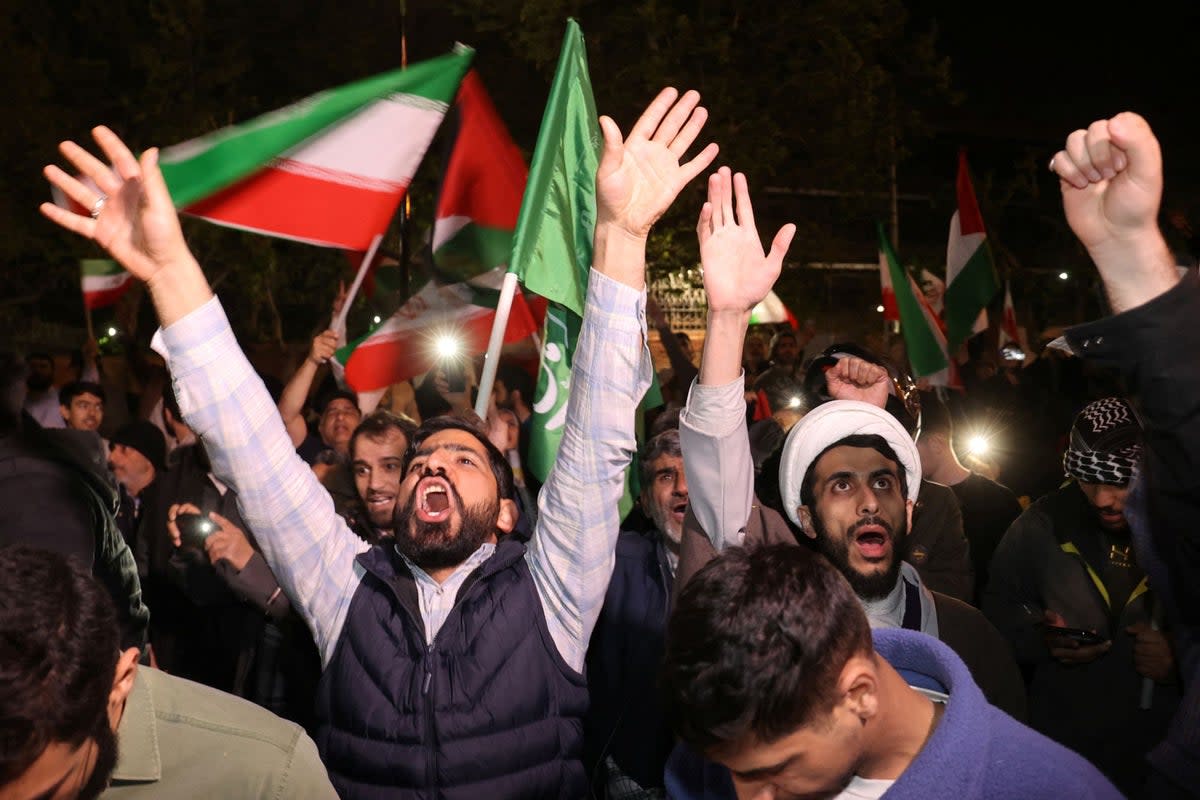 Iranian demonstrators react after the attack on Israel (via REUTERS)