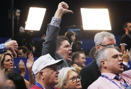 Republican National Convention delegates scream and gesture as the Chair announces that the convention will not hold a roll-call vote on the Republican National Convention Rules Committee's report and rules changes and rejects the efforts of anti-Trump forces to hold such a vote at the Republican National Convention in Cleveland, Ohio, U.S. July 18, 2016. REUTERS/Brian Snyder TPX IMAGES OF THE DAY