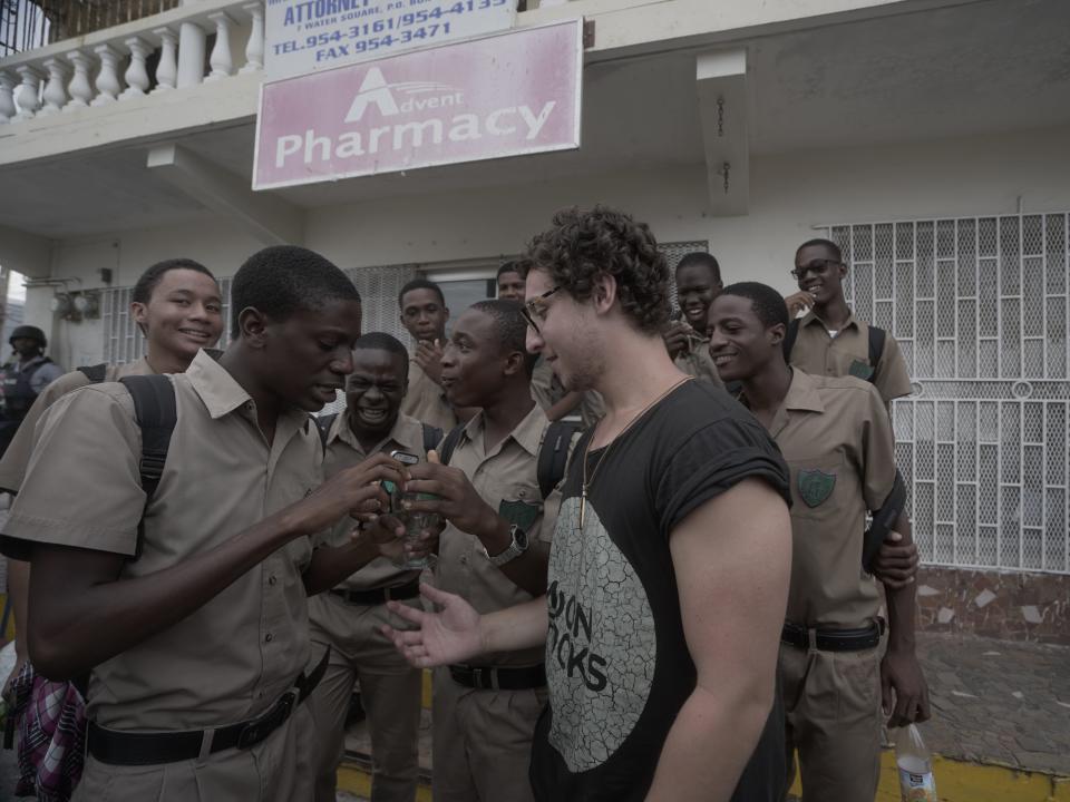 Julius Dein doing magic for a crowd on the street.