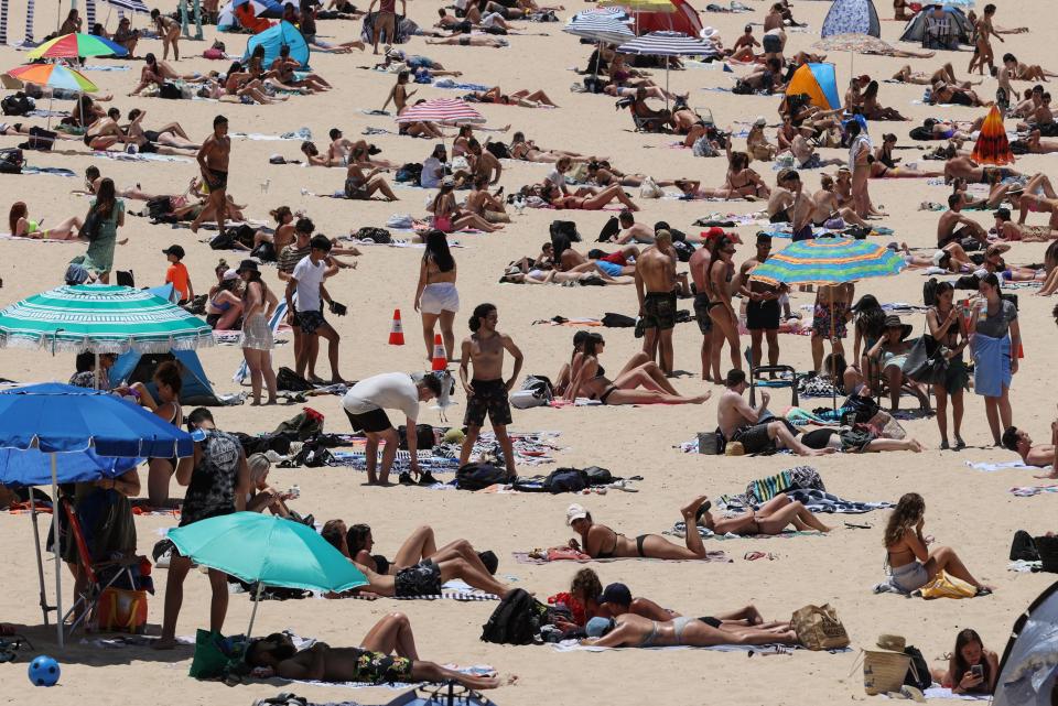 <p>Beachgoers enjoy a summer day at Coogee Beach in Sydney</p> (REUTERS)