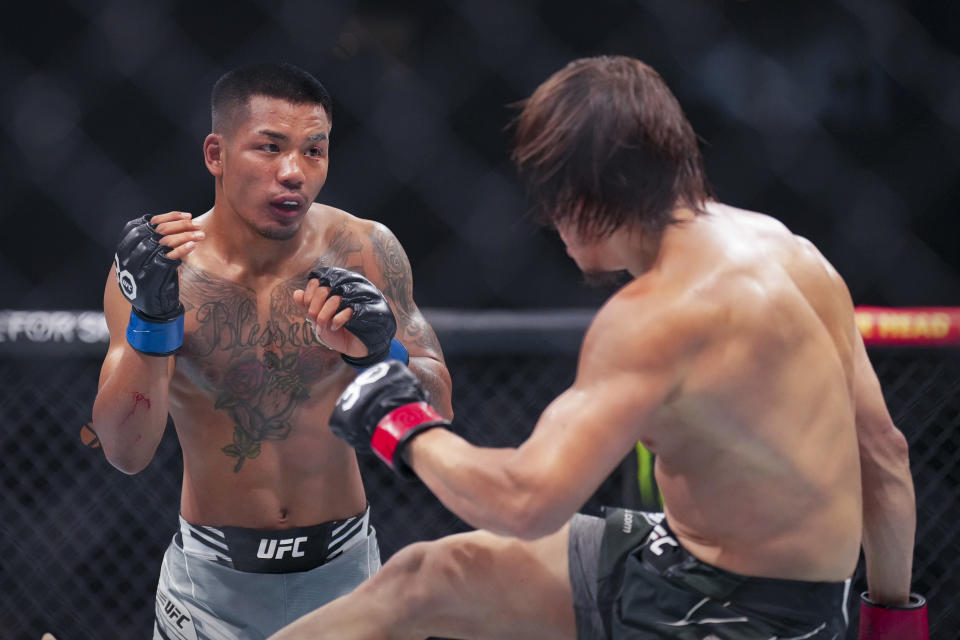 Jun 24, 2023; Jacksonville, Florida, USA; Zhalgas Zhumagulov (red gloves) fights Joshua Van (blue gloves) in a flyweight bout during UFC Fight Night at VyStar Veterans Memorial Arena. Mandatory Credit: David Yeazell-USA TODAY Sports