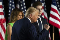 President Donald Trump pumps his fist after speaking, with first lady Melania Trump, and son Barron Trump, on the South Lawn of the White House on the fourth day of the Republican National Convention, Thursday, Aug. 27, 2020, in Washington. (AP Photo/Alex Brandon)