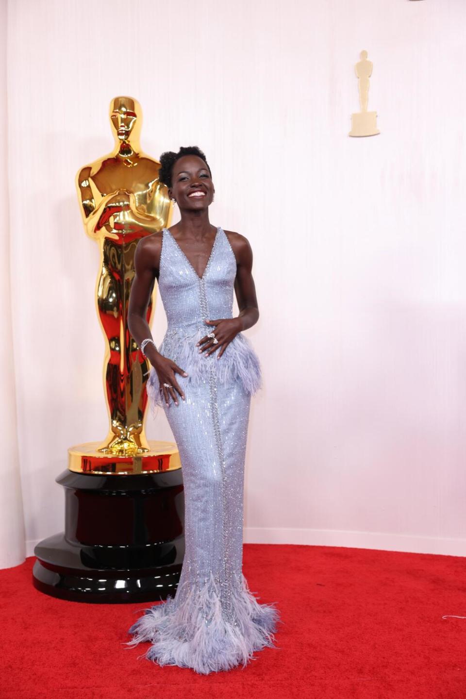 Lupita Nyong'o wears a feathered pale blue dress.