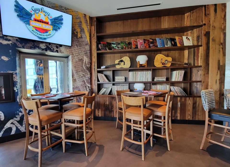 The bar area of Guy Fieri's Kitchen + Bar in Council Bluffs features vinyl albums and two signed Fender guitars.