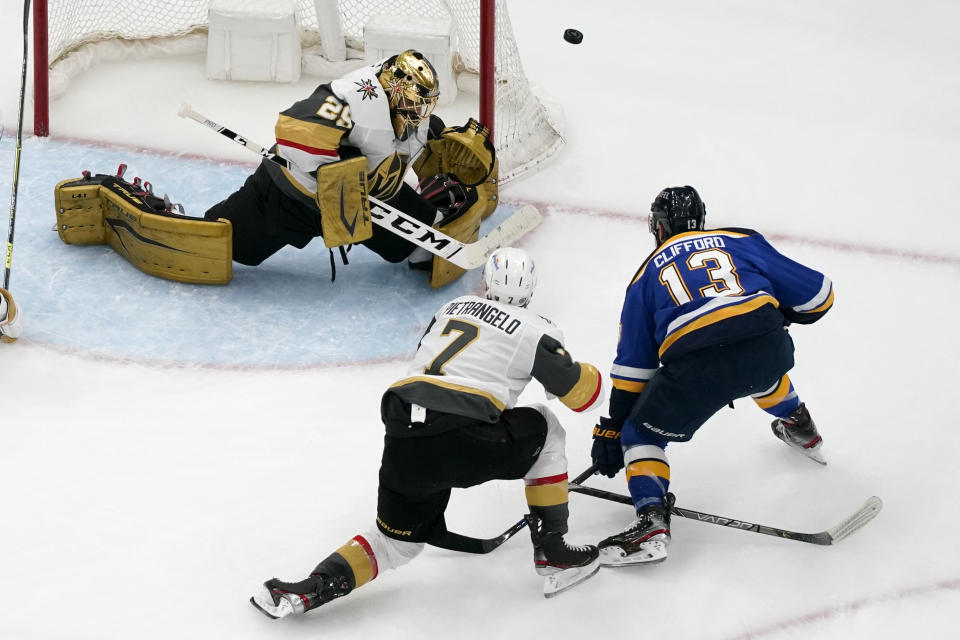 Vegas Golden Knights goaltender Marc-Andre Fleury (29) defects a shot from St. Louis Blues' Kyle Clifford (13) as Vegas Golden Knights' Alex Pietrangelo (7) watches during the third period of an NHL hockey game Wednesday, April 7, 2021, in St. Louis. (AP Photo/Jeff Roberson)