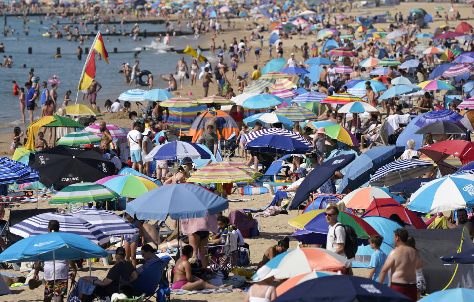 People gather in the hot weather at Bournemouth beach in Dorset. A drought is set to be declared for some parts of England on Friday, with temperatures to hit 35C making the country hotter than parts of the Caribbean. Picture date: Friday August 12, 2022.