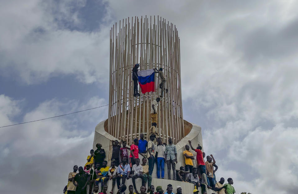 Supporters of Niger's ruling junta hold a Russian flag at the start of a protest called to fight for the country's freedom and push back against foreign interference in Niamey, Niger, on Aug. 3, 2023. Russia's Wagner Group, a private military company led by Yevgeny Prigozhin, has played a key role in the fighting in Ukraine and also deployed its personnel to Syria, Libya and several African countries. Prigozhin's presumed death in a plane crash along with some of his top lieutenants raises doubts about the future of the military contractor. (AP Photo/Sam Mednick, File)