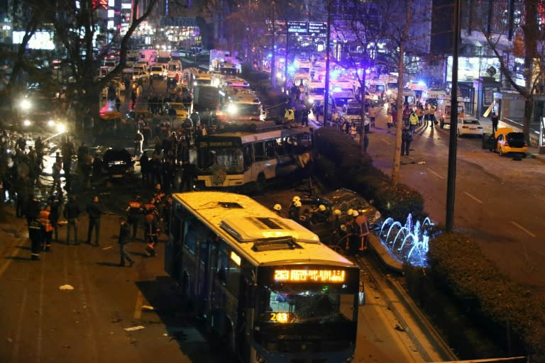 Police, firefighters and emergency services work at the site of a blast in Ankara on March 13, 2016