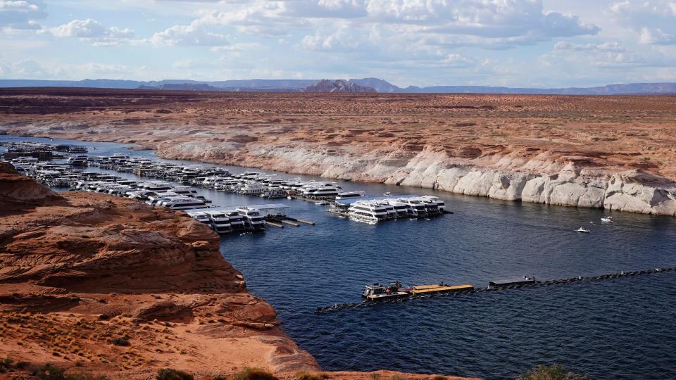 A white band of newly exposed rock is shown along the canyon walls at Lake Powell at Antelope Point Marina on July 30, 2021, near Page, Ariz. It highlights the difference between the current lake level and the lake's high-water mark.