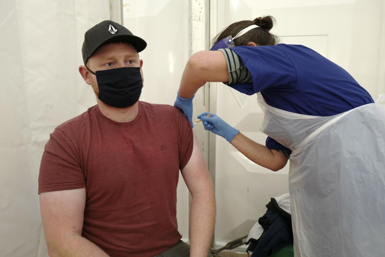 Jamie Burnett, 28, a Garden Therapist working for Age UK, received the AstraZeneca/Oxford COVID-19 vaccination on Feb. 1, 2021, in the vaccination center at the Royal Cornwall Showground in Wadebridge, England. The National Coastguard Service has been added to the list of essential services. In total 50 large-scale vaccination centers are available across England.