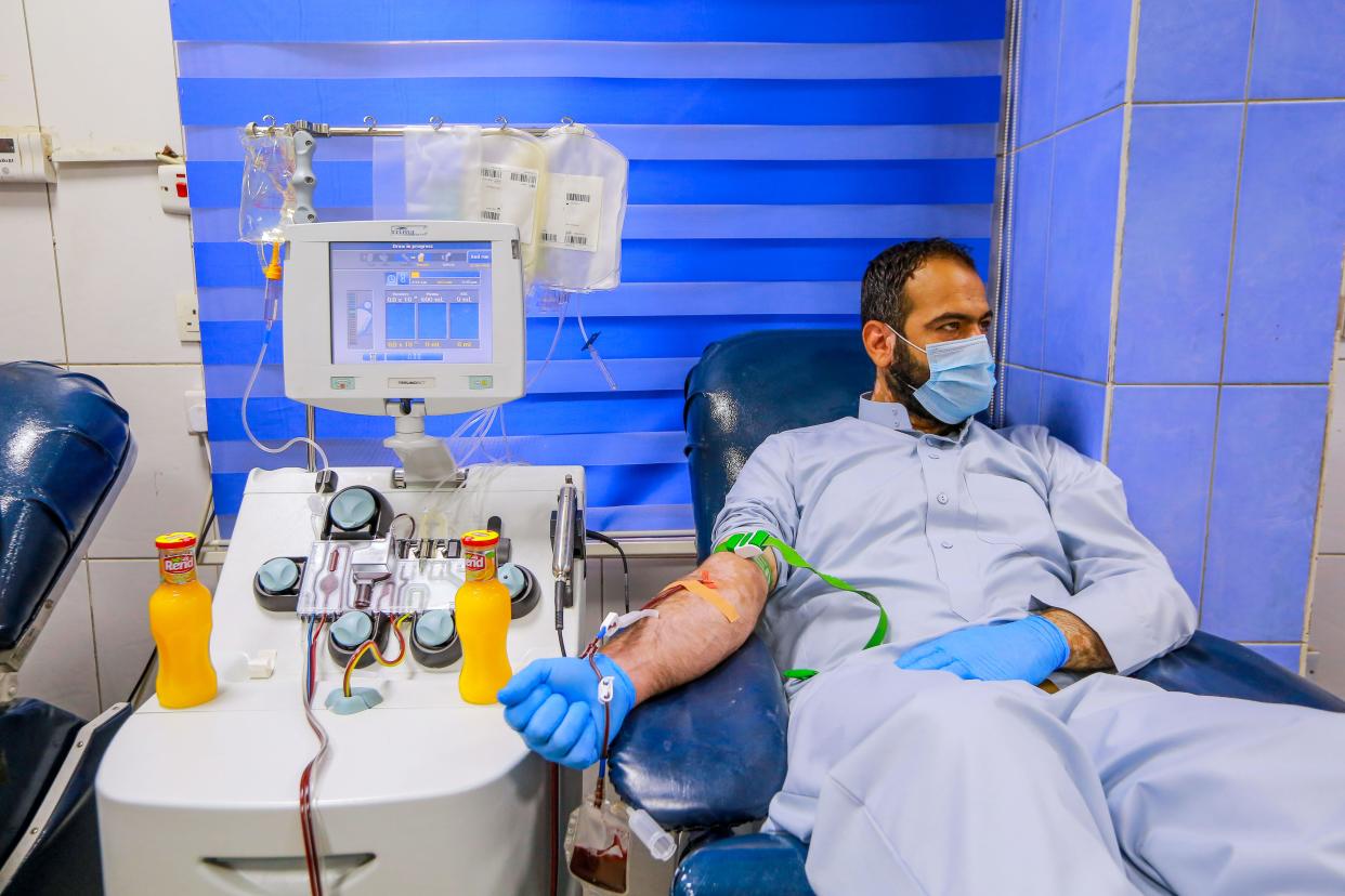 A recovered coronavirus (COVID-19) patient donates blood samples for plasma extraction to help critically ill patients at the National Blood Transfusion Center.