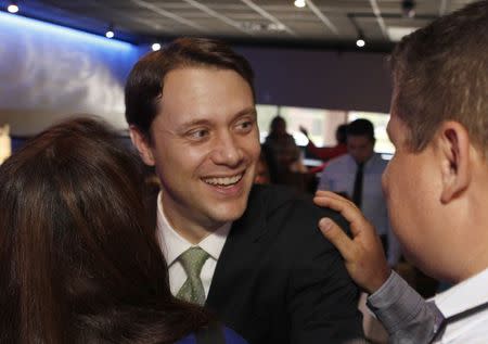 Georgia State Senator (D-Decatur), and gubernatorial candidate Jason Carter hugs a supporter after speaking at a private event in Tucker, Georgia May 23, 2014. REUTERS/Tami Chappell