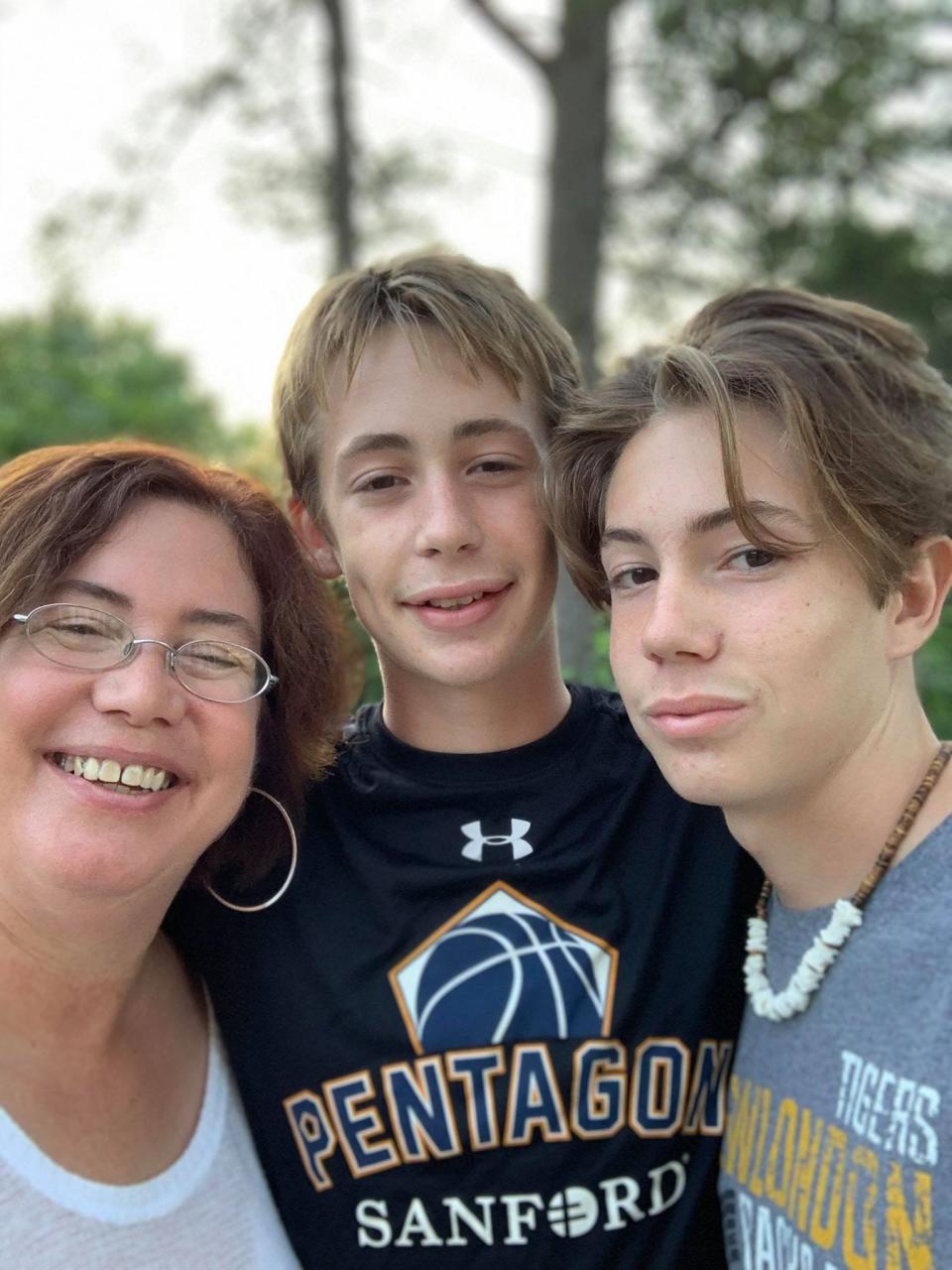 Cris Julian, left, and Ethan Julian, right, were still waiting for their coronavirus test results on July 15, 12 days after they were tested. Alexander Julian, center, got tested the same day and at the same place and learned he was positive 48 hours later.