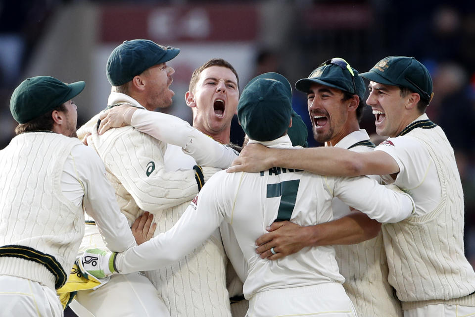 Australia players celebrate after winning the fourth test and retaining the Ashes during day five of the fourth Ashes Test cricket match between England and Australia at Old Trafford in Manchester, England, Sunday Sept. 8, 2019. (AP Photo/Rui Vieira)