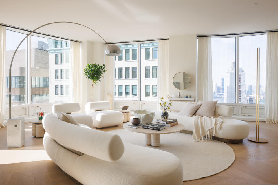 A living room with curving furniture