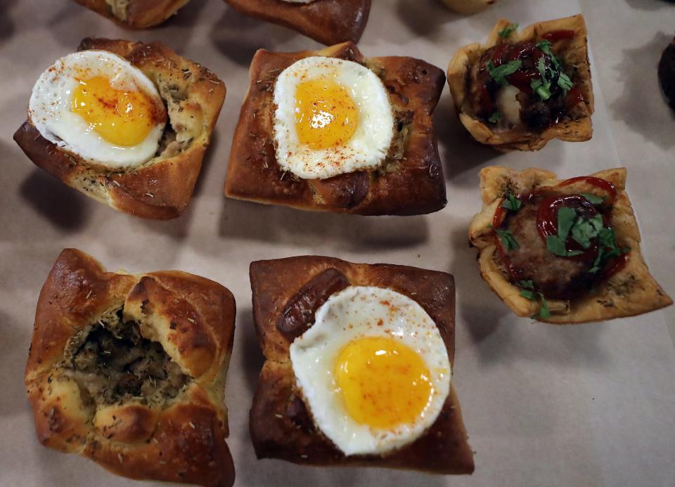 Savory bites like puff pastry with pork sausage, gravy and egg (left and center) and scotch eggs baked in puff pastry (at right) await customers at Ma Façon TR in Poulsbo on Thursday, June 13, 2024.