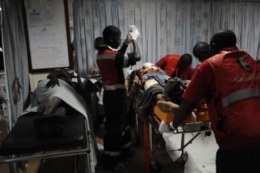 A man is assisted into the hospital after an attack at a bus station in Nairobi. Kenya faced a new terror threat after a grenade attack blamed on Somali Islamist militia killed six people and injured 63 in a bus terminal in the capital Nairobi