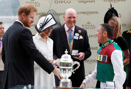 Horse Racing - Royal Ascot - Ascot Racecourse, Ascot, Britain - June 19, 2018 Frankie Dettori celebrates after winning the 4.20 St James's Palace Stakes as Britain's Prince Harry and Meghan, the Duchess of Sussex look on Action Images via Reuters/Paul Childs