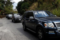 A group of vehicles are driven on the road after leaving the house of the Venezuelan opposition leader Juan Guaido, who many nations have recognised as the country's rightful interim ruler, in Caracas, Venezuela February 21, 2019. REUTERS/Carlos Garcia Rawlins