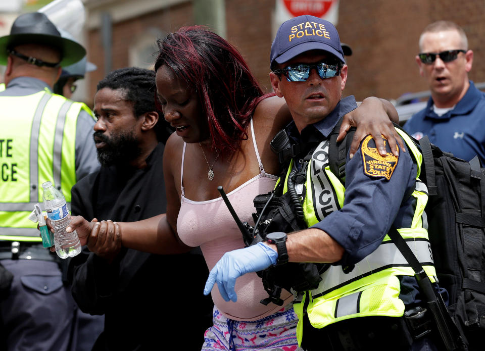 <p>Rescue workers assist a victim who was injured when a car drove through a group of counter protestors at the “Unite the Right” rally Charlottesville, Va., Aug. 12, 2017. (Photo: Joshua Roberts/Reuters) </p>