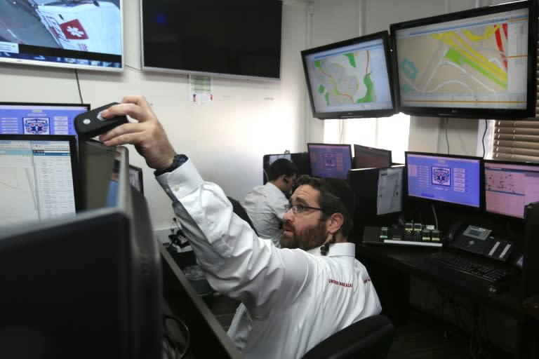 Volunteers of "United Hatzalah", a network of volunteer medics across Israel, monitor screens at the organisation's heaquarters in West Jerusalem