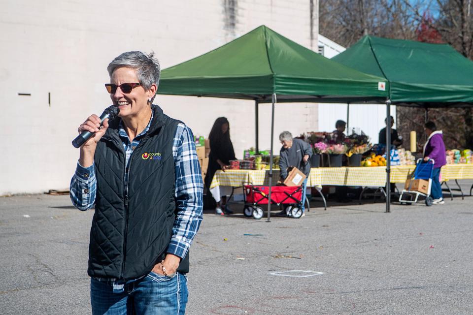 Paula Sellars, associate director of Bounty & Soul, makes a few announcements before the opening of the community market in Black Mountain, November 14, 2023.