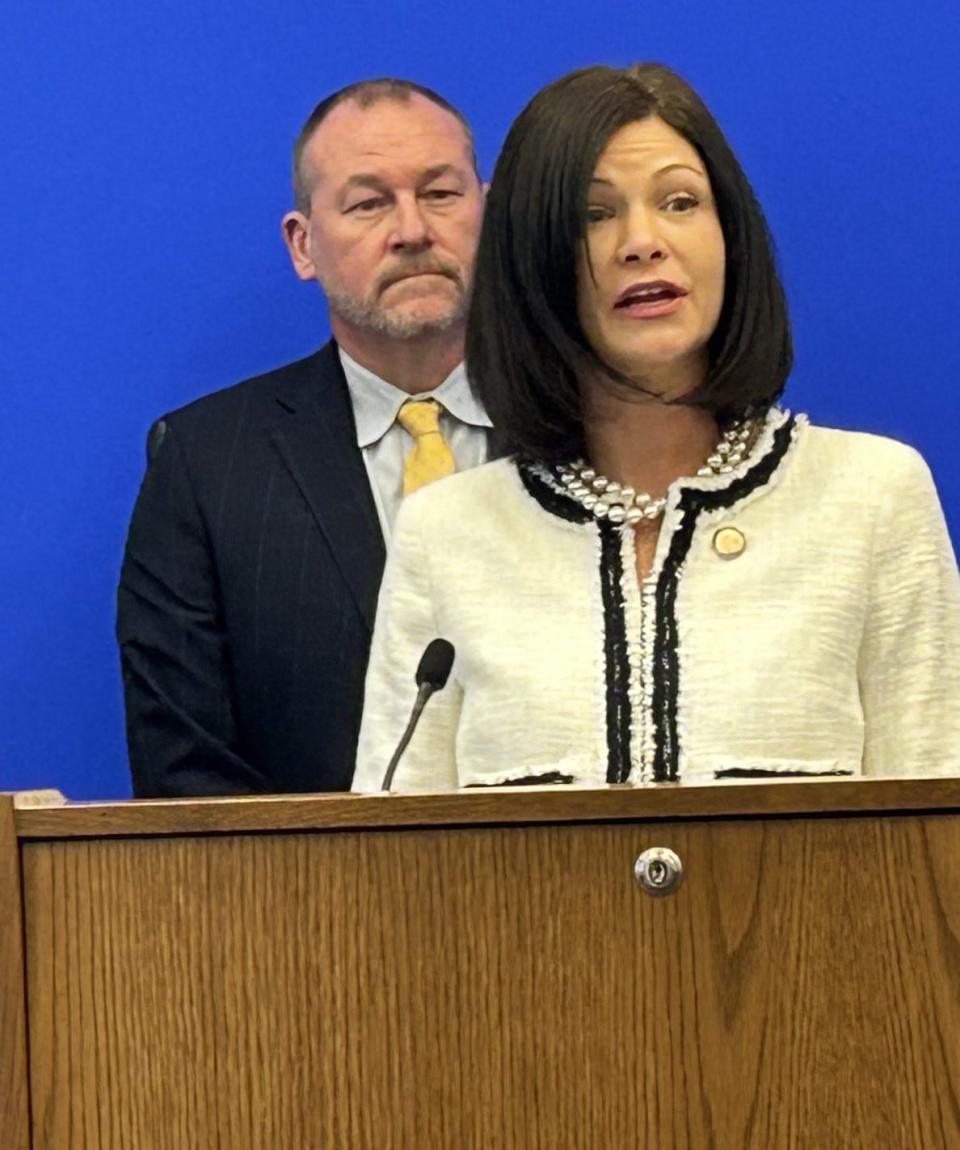 As Del. Mike Cherry, R-Colonial Heights, listens, Del. Karrie Delaney, D-Fairfax County, speaks during a news conference Wednesday, Jan. 10, 2024, at the General Assembly Building in Richmond. Cherry and Delaney are co-sponsoring legislation that would prohibit human trafficking for labor purposes in the state. The Youngkin administration and the Virginia attorney general's office are also behind the measure.