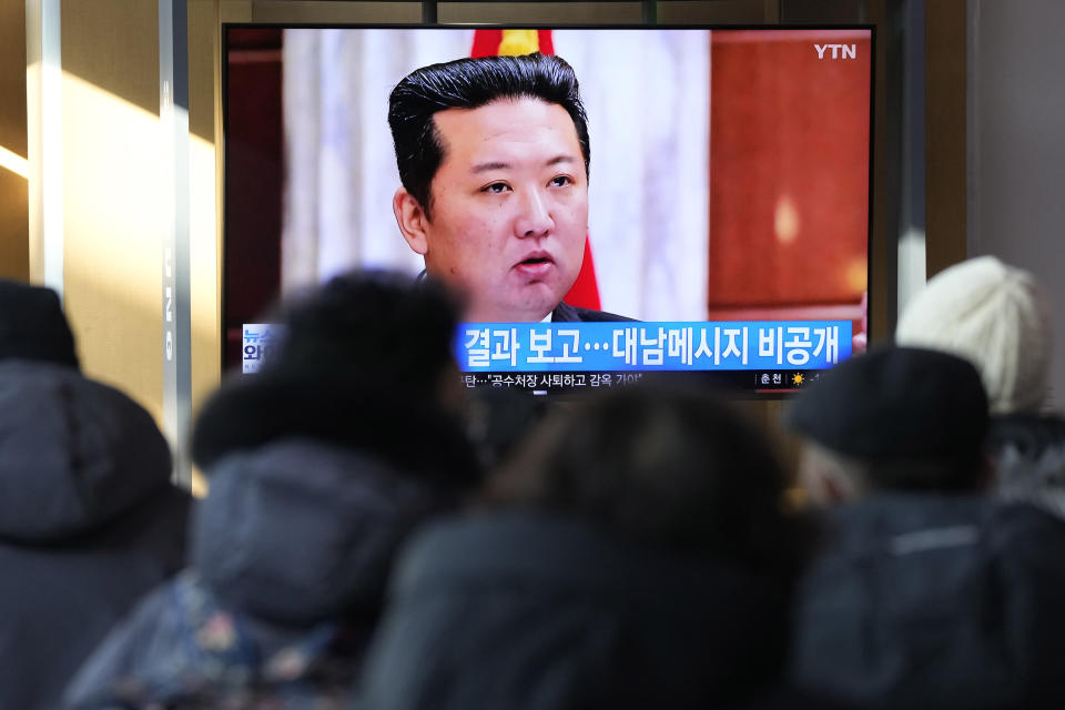 People watch a TV screen showing an image of North Korean leader Kim Jong Un at a meeting of the Central Committee of the ruling Workers' Party, during a news program at the Seoul Railway Station in Seoul, South Korea, Saturday, Jan. 1, 2022. Kim vowed to further bolster his military capability, maintain draconian anti-virus measures and push hard to improve the economy during a speech at a key political conference this week, state media reported Saturday. The Korean letters read "The messages about South Korea were not be revealed." (AP Photo/Ahn Young-joon)