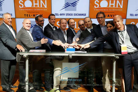 Speakers, including UK hedge fund Lansdowne Partners Chairman Stuart Roden (3rd R), LW Partners Chairman and Chief Executive Leon Wagner (2nd L) and Hudson Bay Capital Management Chief Executive and Chief Investment Officer Sander Gerber (4th R), take part in the opening bell ceremony of the Tel Aviv Stock Exchange before the Sohn Conference in Israel October 26, 2016. REUTERS/Baz Ratner