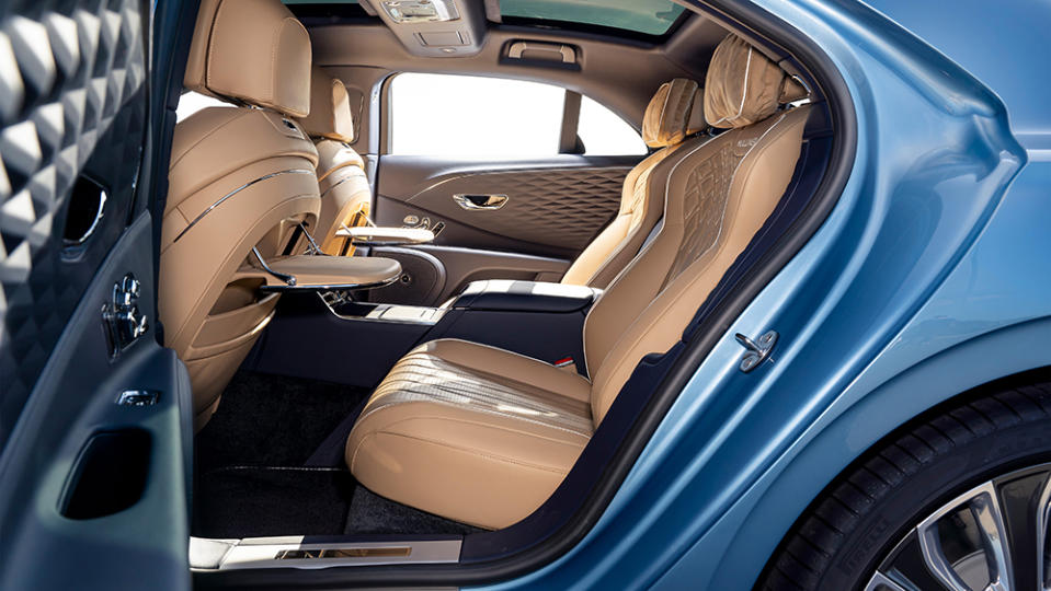 The backseat with both electronically operated picnic tables displayed. - Credit: Bentley