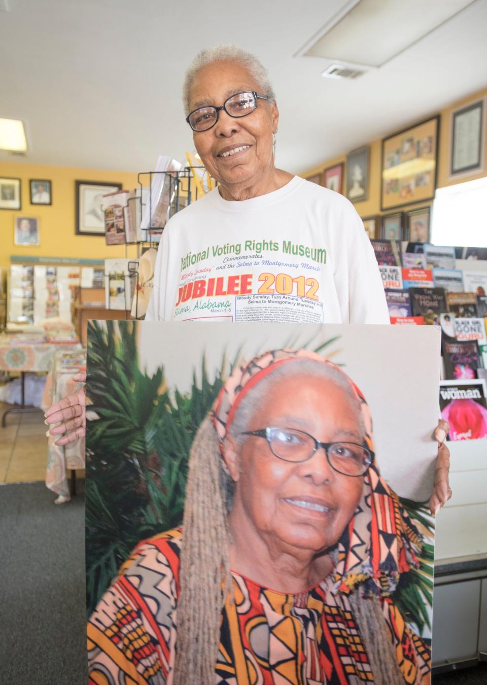 Georgia Blackmon shows off her new haircut along with a photo of herself with her trademark hairstyle at The Gathering Awareness and Book Center in downtown Pensacola on Monday, December 17, 2018. Blackmon died at age 82 on Monday, Sept. 18, 2023.