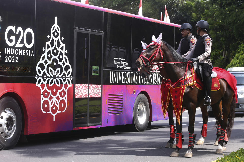 Mounted police patrol a street ahead of the G20 Summit in Nusa Dua, Bali, Indonesia, Sunday, Nov. 13, 2022. Indonesia is gearing up to host the gathering of the leaders of the world's biggest economies this week. (AP Photo/Firdia Lisnawati)