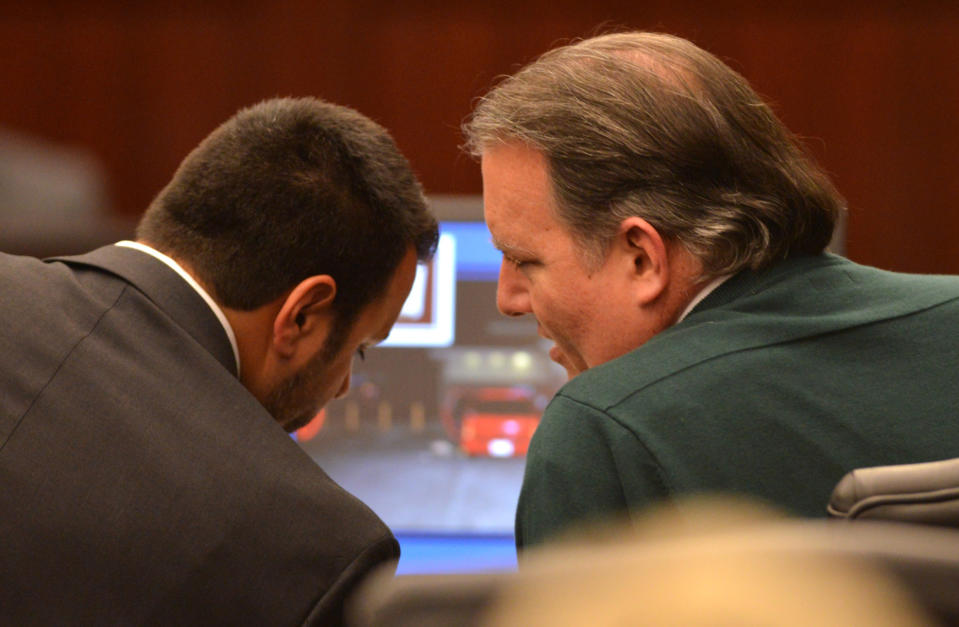 Defense attorney Cory Strolla, left, talks with Michael Dunn during the first day of Dunn's trial in Jacksonville, Fla., Thursday Feb. 6, 2014. Michael Dunn is charged in the shooting death of Jordan Davis who was outside a Jacksonville store with friends in November 2012. (AP Photo/Bob Mack, Pool)
