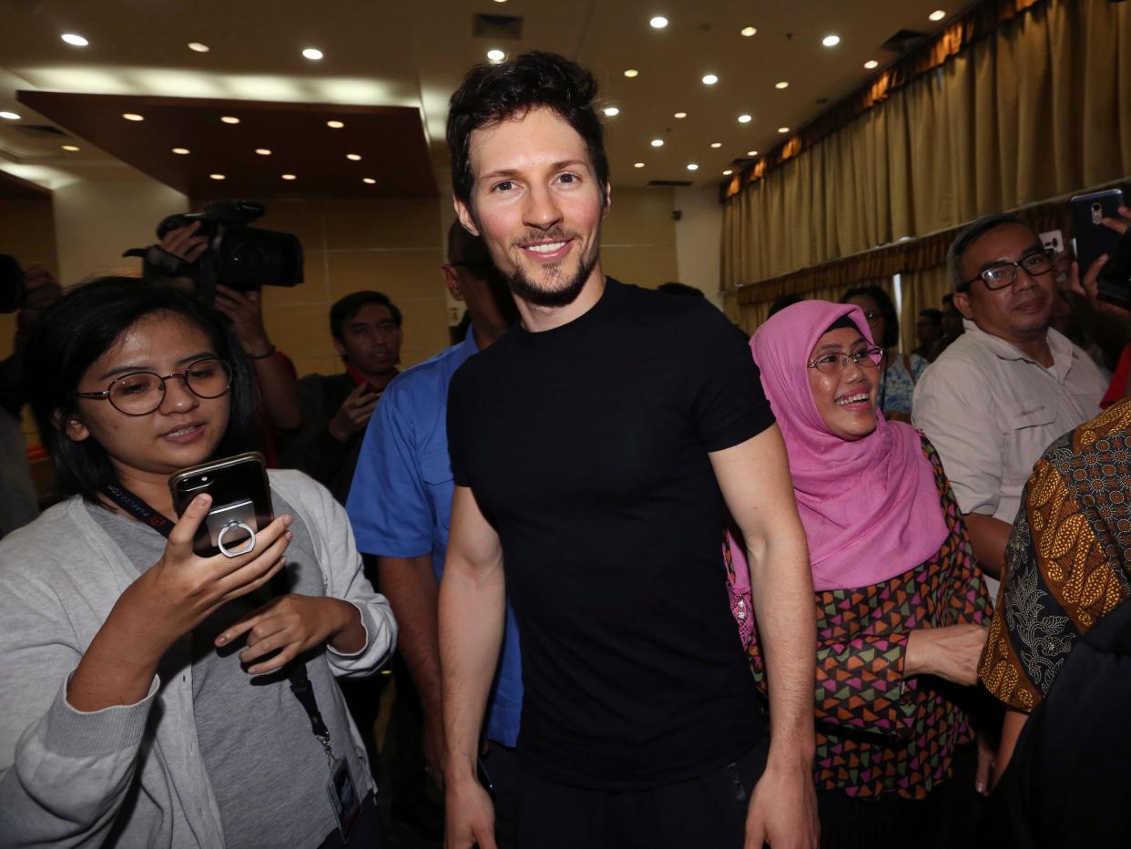 Telegram co-founder Pavel Durov, center, smiles following his meeting with Indonesian Communication and Information Minister Rudiantara in Jakarta, Indonesia in 2017.