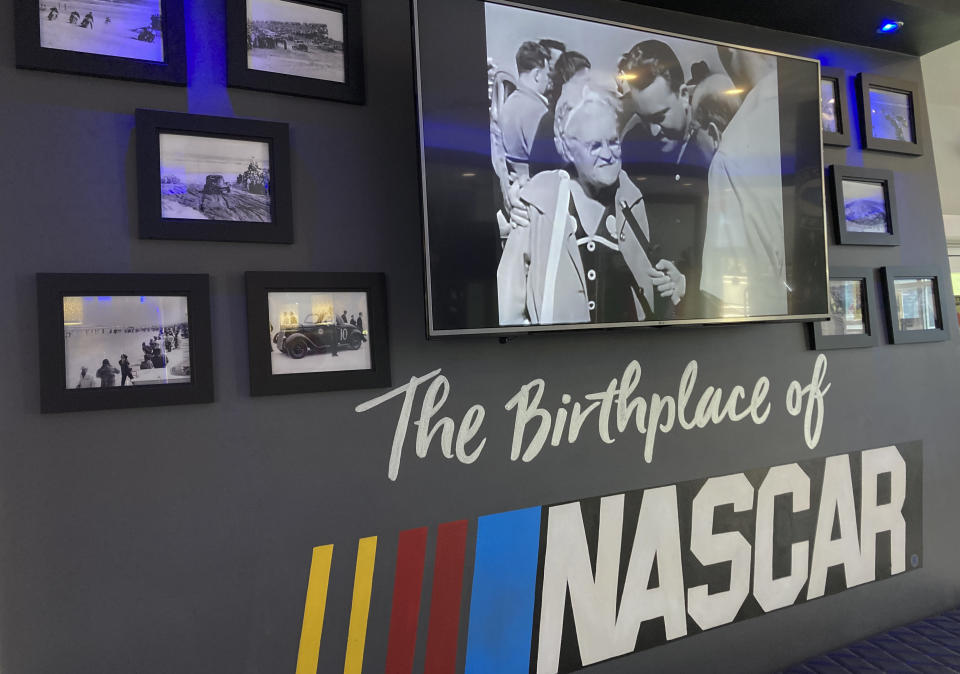 Photos and memorabilia are displayed in the lobby of the Streamline Hotel in Daytona Beach, Fla., on Friday, Jan 27, 2023. The Streamline Hotel, which opened in 1941 and was recognized as the birthplace of NASCAR because of its history of hosting meetings between drivers and officials, has once again become an icon near the famous beach. (AP Photo/Mark Long)
