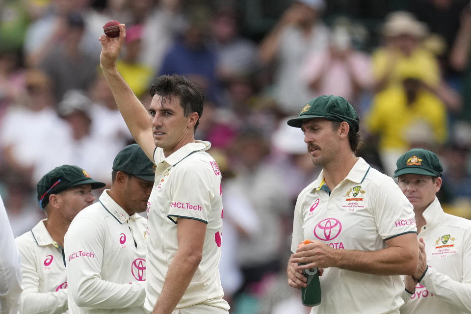 Australia's Pat Cummins holds up the ball after taking 5 wicket against Pakistan during their cricket test match in Sydney, Wednesday, Jan. 3, 2024. (AP Photo/Rick Rycroft)