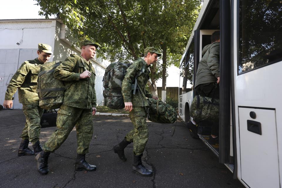 FILE - Russian recruits take a bus near a military recruitment center in Krasnodar, Russia, Sunday, Sept. 25, 2022. Last week, Russian President Vladimir Putin also raised the stakes by declaring a mobilization of reservists to beef up his troops in Ukraine that is aimed to call up at least 300,000. (AP Photo, File)