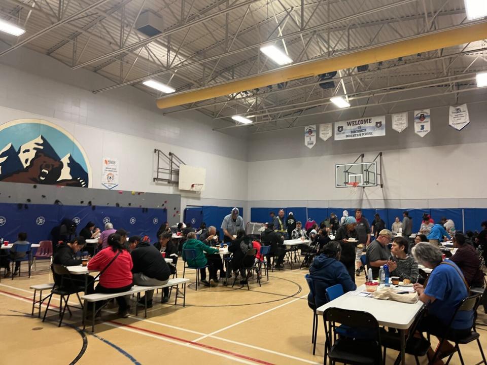 Evacuees from Fort Good Hope gather for a meal in the Mackenzie Mountain School gym in Norman Wells. 